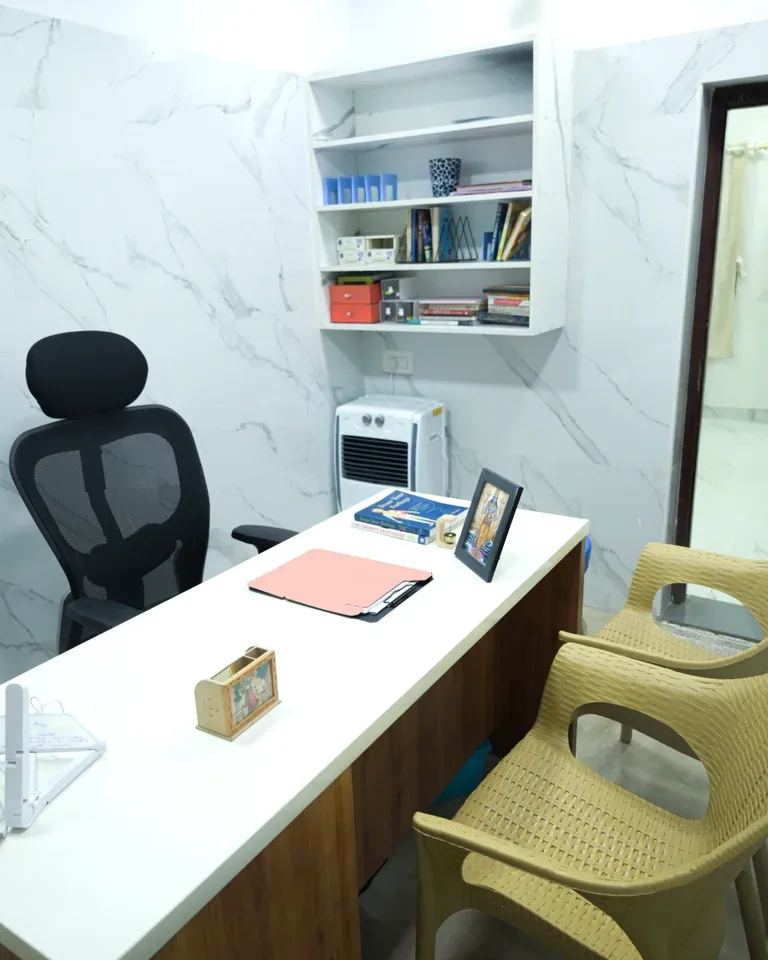 Consultation room with a desk and visitor chairs at the Coimbatore clinic