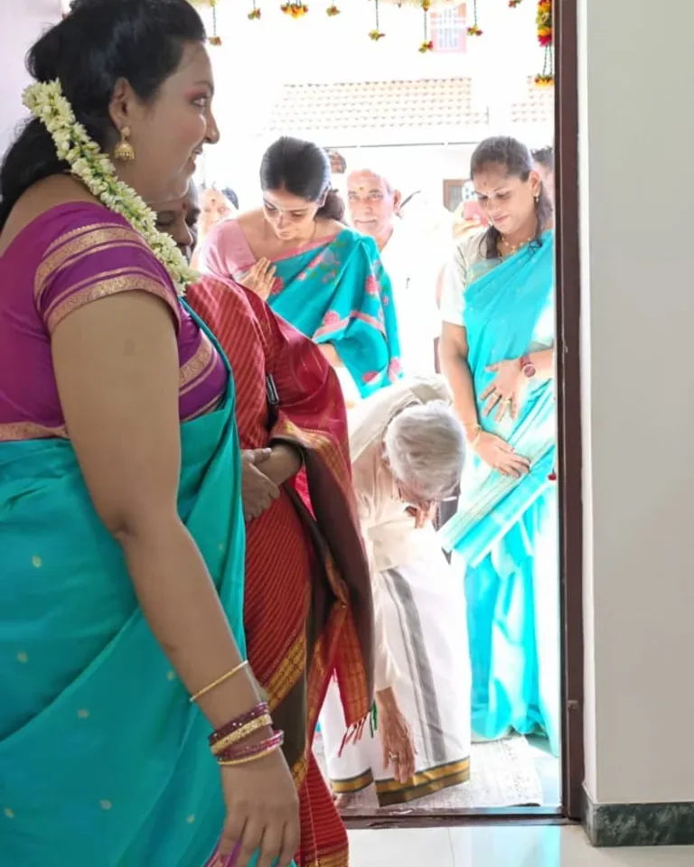 Guests entering through a decorated clinic doorway during the inauguration